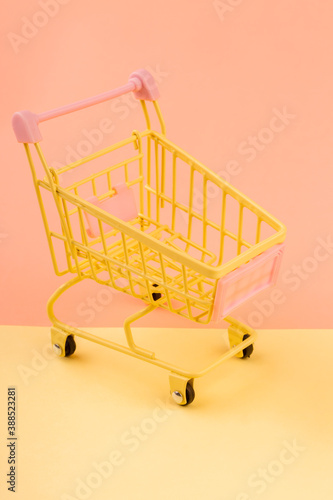 Yellow empty shopping cart. Shopping concept.