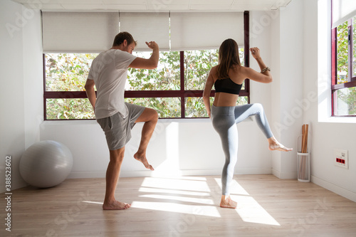One young couple doing exercise at home
