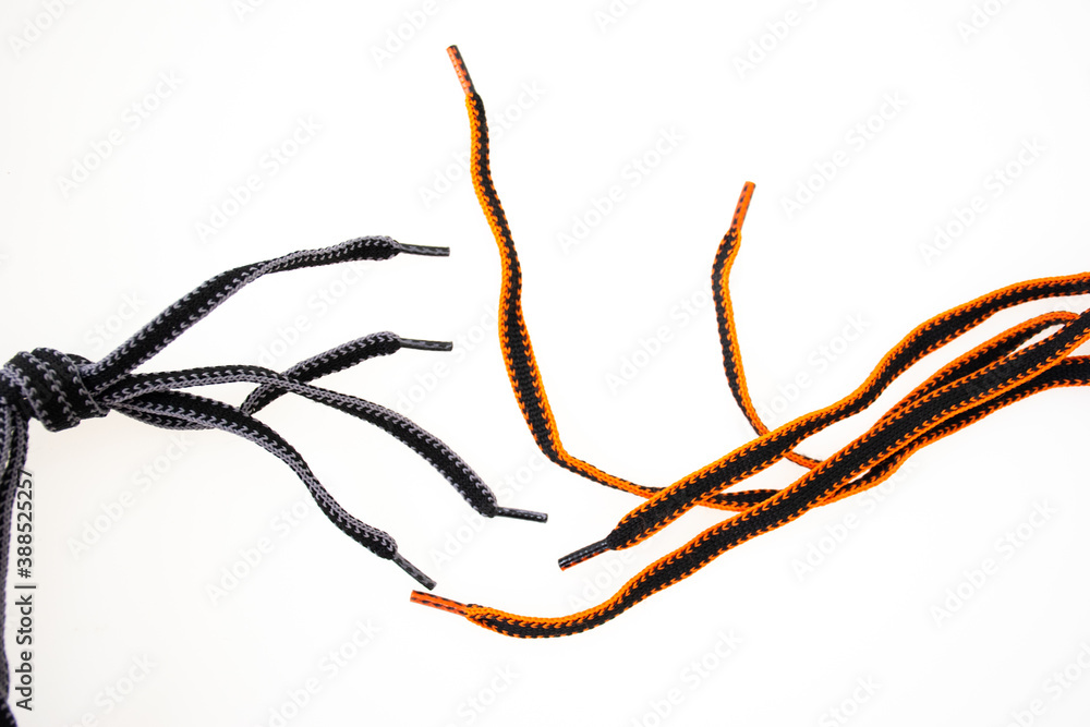 Orange and black shoelaces on white background Orange and black shoelaces on white background