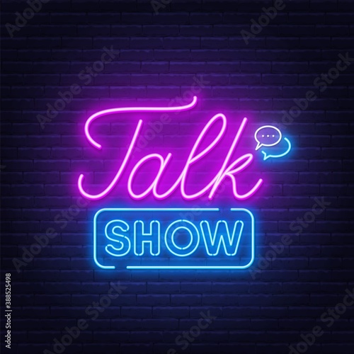 Talk show neon sign on brick wall background .