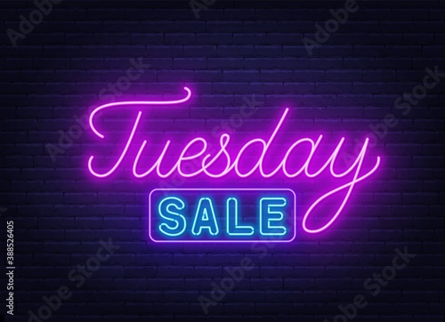 Tuesday Sale neon sign on brick wall background .