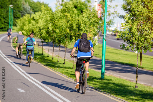Wallpaper Mural Cyclists ride on the bike path in the city Park
 Torontodigital.ca