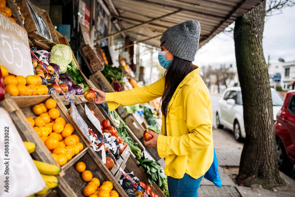 Fototapeta premium Woman Buying in Street Market