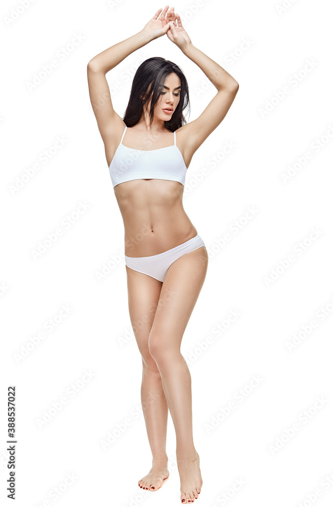 Fitness young woman with a beautiful body on white background