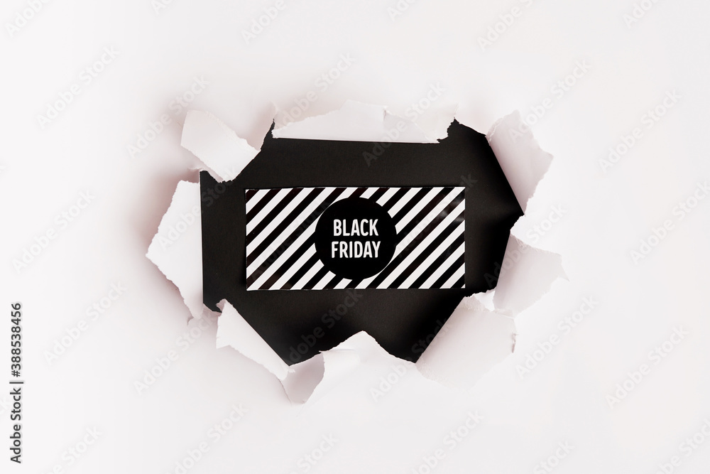white torn paper and the text black friday on black background. Black Friday composition. white torn paper and the text black friday on black background. Black Friday composition.