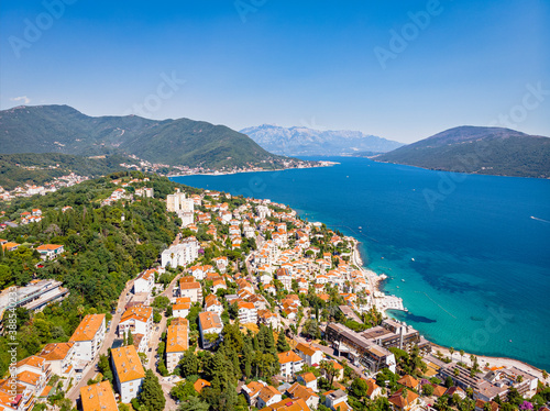 Summer view on houses with red roof and Bay of Kotor (Herceg Novi, Montenegro). Drone aerial shot
