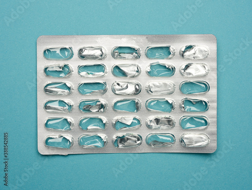 blank blister pack of capsule pills on a blue background photo