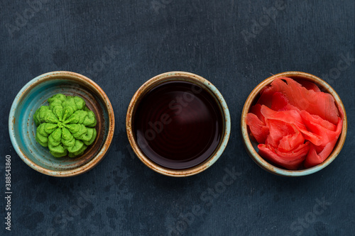 a classic set for sushi with wasabi, soy sauce and ginger photo