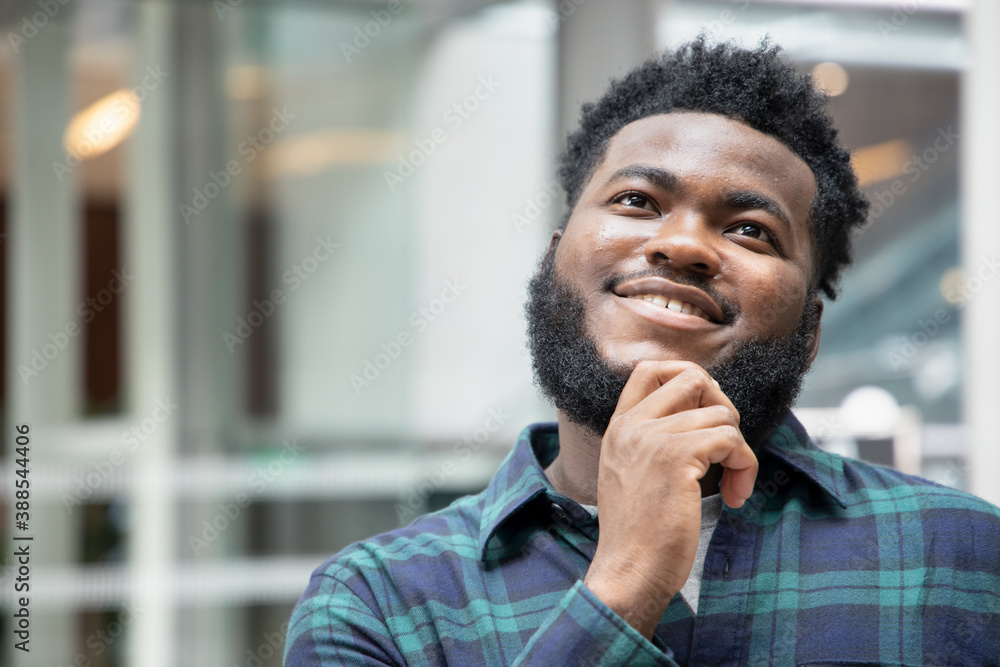 Happy African black man thinking, planning, finding good idea Happy African black man thinking, planning, finding good idea