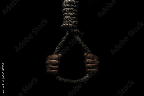 Tapeta Hand holds a noose on a black background