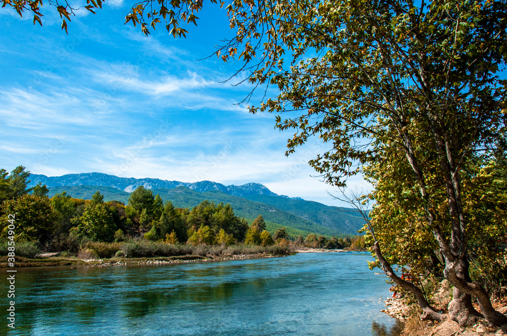 Koprucay or koprulu river valley with Taurus mountains and rocks, Turkey. Famous by its rafting spots. Stream rapids at the foreground Koprucay or koprulu river valley with Taurus mountains and rocks, Turkey. Famous by its rafting spots. Stream rapids at the foreground