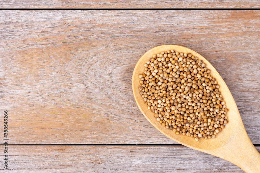 White pepper in wooden spoon on wood White pepper in wooden spoon on wood