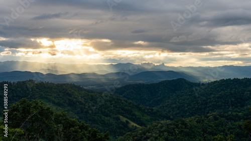Golden Sun ray through cloudy sky with long mountain range in Tak, Thailand