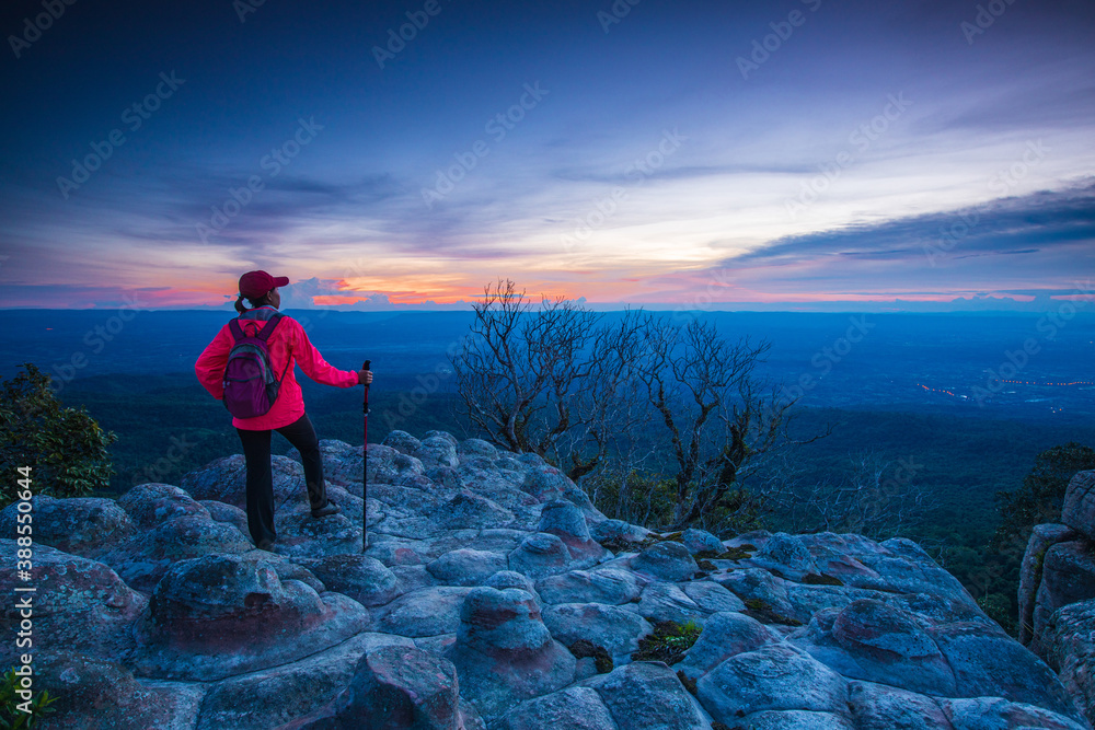 Young woman hiking on mountains. Lan-hin-pum, Phu Hin Rong Kla National park, Phitsanulok province , Thailand. Young woman hiking on mountains. Lan-hin-pum, Phu Hin Rong Kla National park, Phitsanulok province , Thailand.