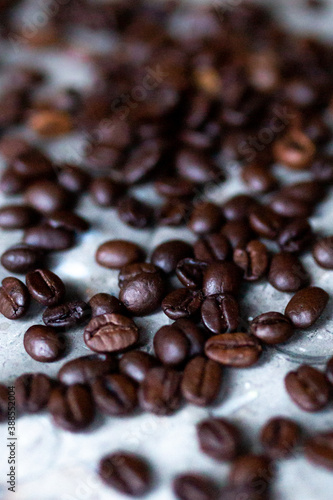 Closeup of dark coffee beans decoratively placed on a marble plate