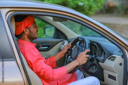 Happy young indian farmer driving new car © PRASANNAPIX