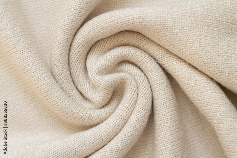 Background of woolen knit beige warm sweater top view Background of woolen knit beige warm sweater top view