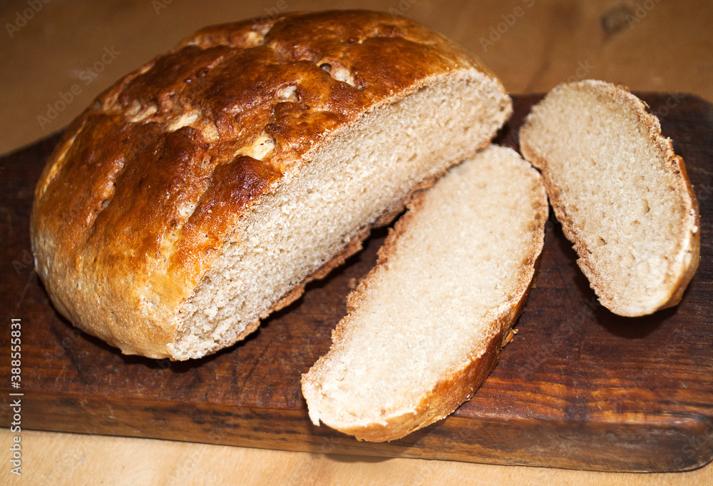 Bread made from several types of flour and starch, gluten free on a wooden background. Two slices of sliced bread with crumbs. Place for text. Banner for a design project.