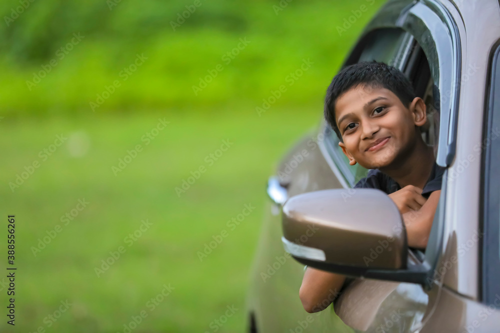 Cute Indian child showing face expression in car Cute Indian child showing face expression in car