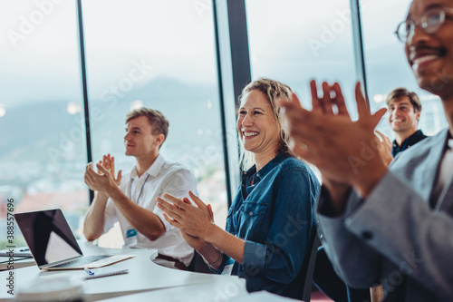 Business professionals clapping hands in conference photo