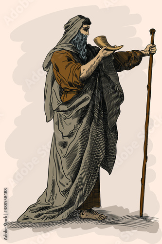 The ancient mythological character Moses walks across the desert with a staff and a horn in his hand.