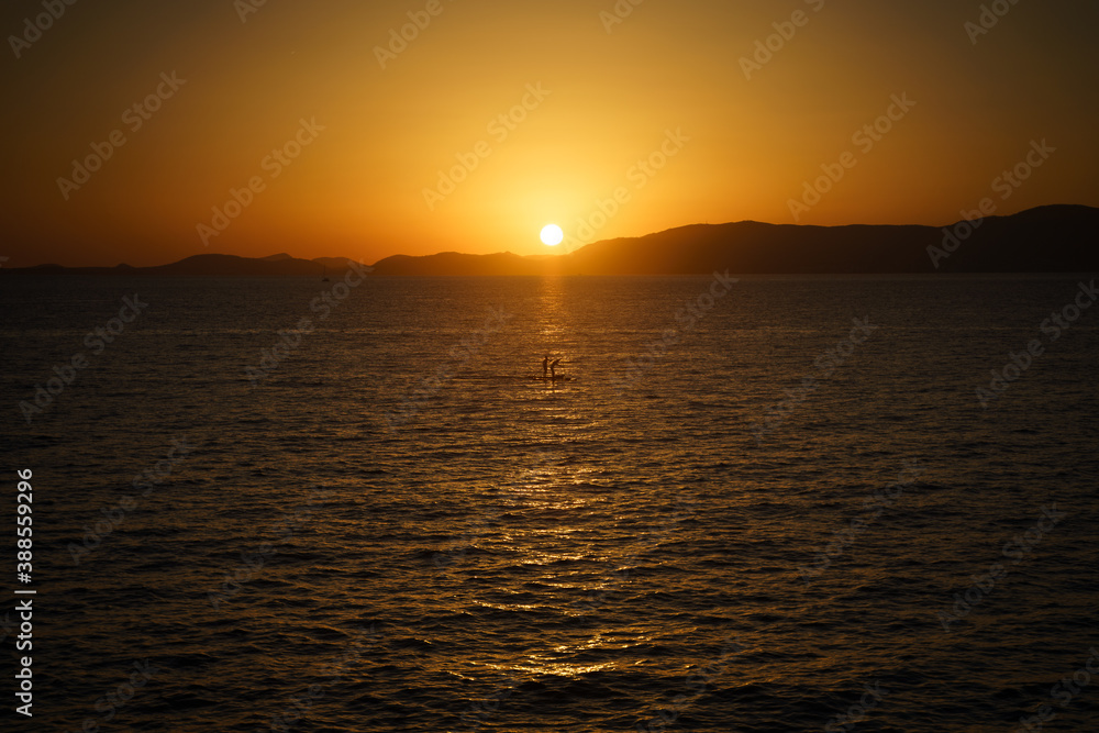 Beautiful orange sunset by the sea in Mallorca, Spain Beautiful orange sunset by the sea in Mallorca, Spain