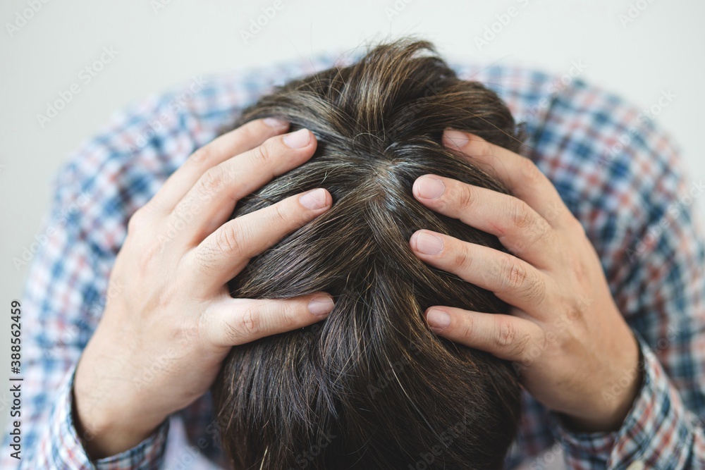 Naklejka premium Closeup sad asian young man and gray hair with worried