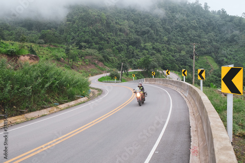 beautiful road in the mountains against foggy over the tree photo