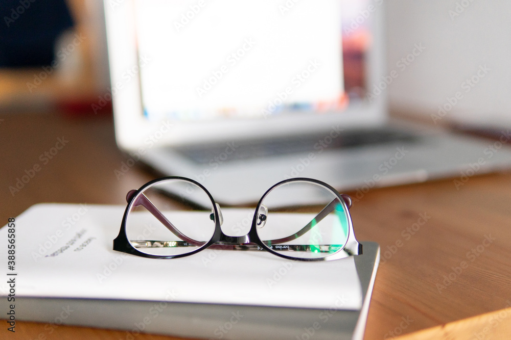 business composition. glasses on the background of a laptop on notepads. business composition. glasses on the background of a laptop on notepads.
