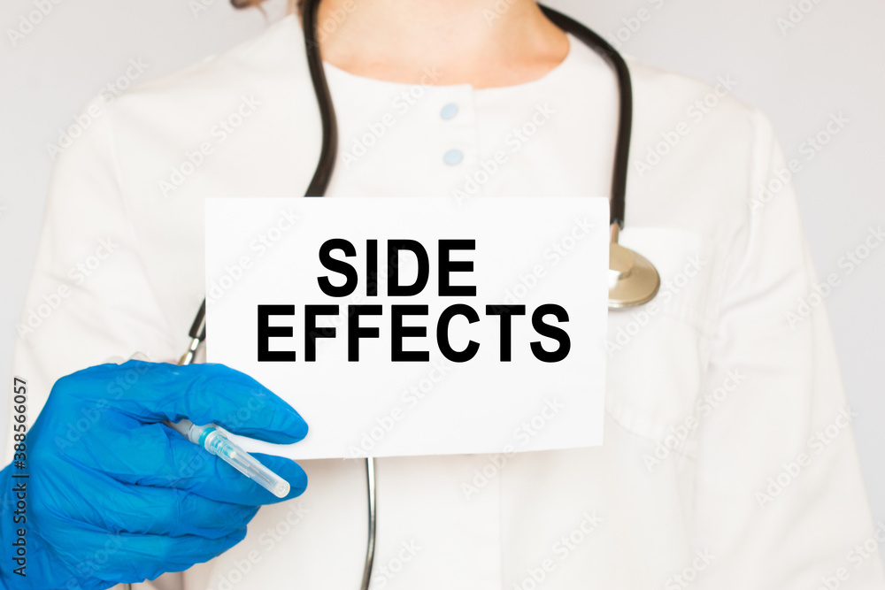 The doctor's blue - gloved hands show the word SIDE EFFECTS - . a gloved hand on a white background. Medical concept. the medicine The doctor's blue - gloved hands show the word SIDE EFFECTS - . a gloved hand on a white background. Medical concept. the medicine
