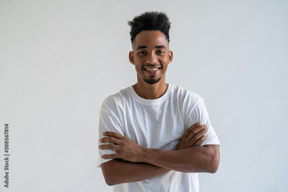 Portrait of a smiling african man with arms folded over white background Portrait of a smiling african man with arms folded over white background
