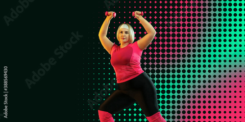 Young caucasian plus size female model's training with weights. Neoned modern artwork, cover, flyer designed. Horizontal with dottes. Concept of sport, healthy lifestyle, body positive, equality. photo