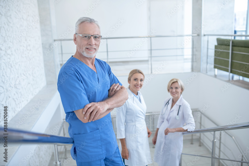 Team of smiling medical workers standing on stairs Team of smiling medical workers standing on stairs