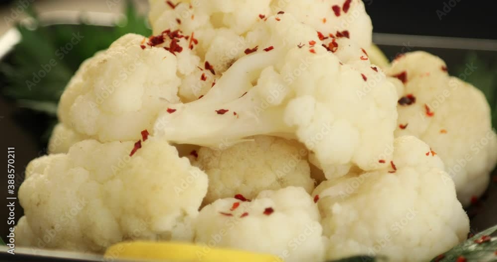 White cauliflower salad rotating on a plate Close up shot White cauliflower salad rotating on a plate Close up shot