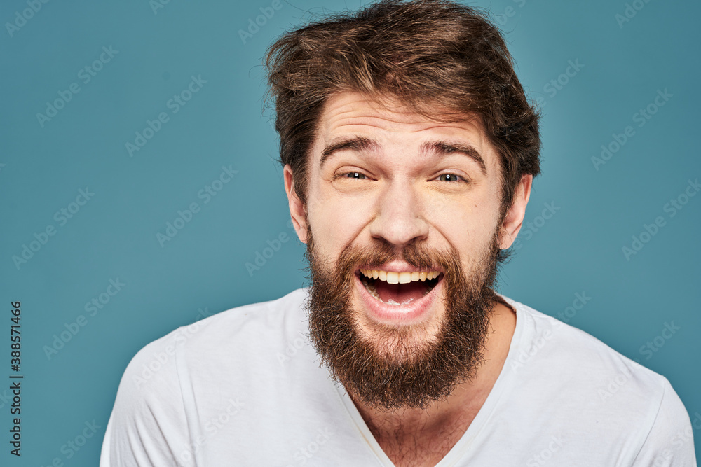 emotional man gesturing with hands lifestyle fun white t-shirt blue isolated stock emotional man gesturing with hands lifestyle fun white t-shirt blue isolated stock