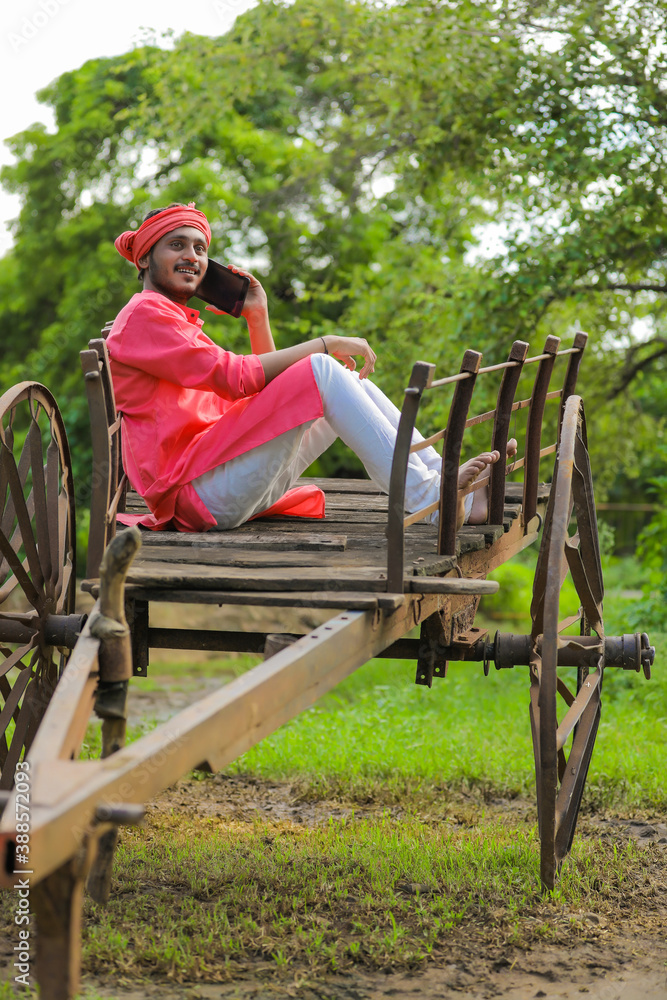 Young indian farmer talking on mobile phone Young indian farmer talking on mobile phone
