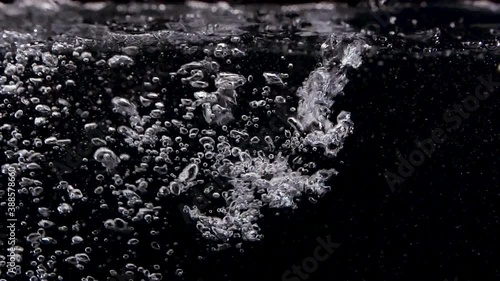 Liquid Bubbles in clean Spa on Black Background Slow Motion photo