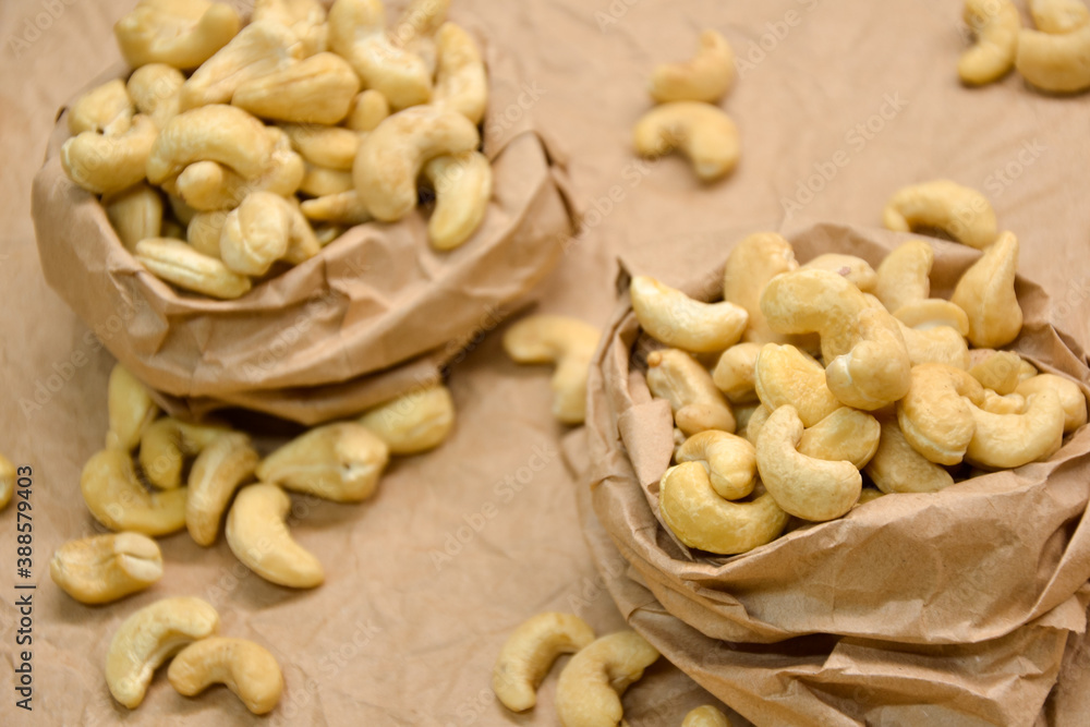 Cashew nuts. Cashew kernels. Clean organic nuts on retro paper background. Organic healthy food. Cashew nuts. Cashew kernels. Clean organic nuts on retro paper background. Organic healthy food.