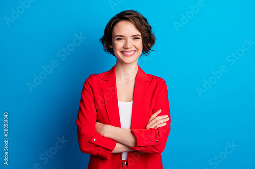 Portrait of attractive content cheerful brown-haired lady folded arms isolated over bright blue color background