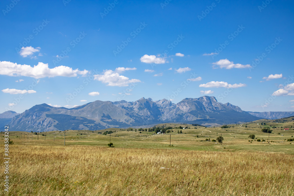 Fototapeta premium Fantastic mountains of Montenegro. Picturesque mountain landscape of Durmitor National Park, Montenegro, Europe, Balkans, Dinaric Alps, UNESCO World Heritage Site. Power lines