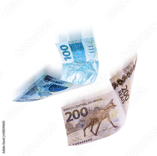 200 and 100 reais banknotes falling, with motion effect, spot blur, isolated white background, concept of fall, crisis and inflation photo