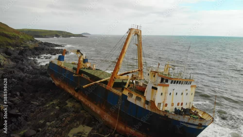 Old Shipswreck stranded on a rocky Beach. Abandoned Ghost Ship Old Shipswreck stranded on a rocky Beach. Abandoned Ghost Ship