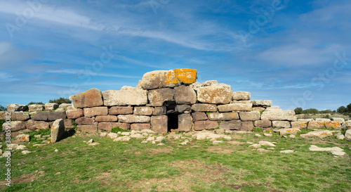 Siddi , Sardinia / Italy - 2020/10/10: Archeological ruins of Nuragic necropolis Giants Tomb of S’omu de S’orcu - Tomba di Giganti Omu de Orcu - with front grave stones of Neolithic cemetery photo