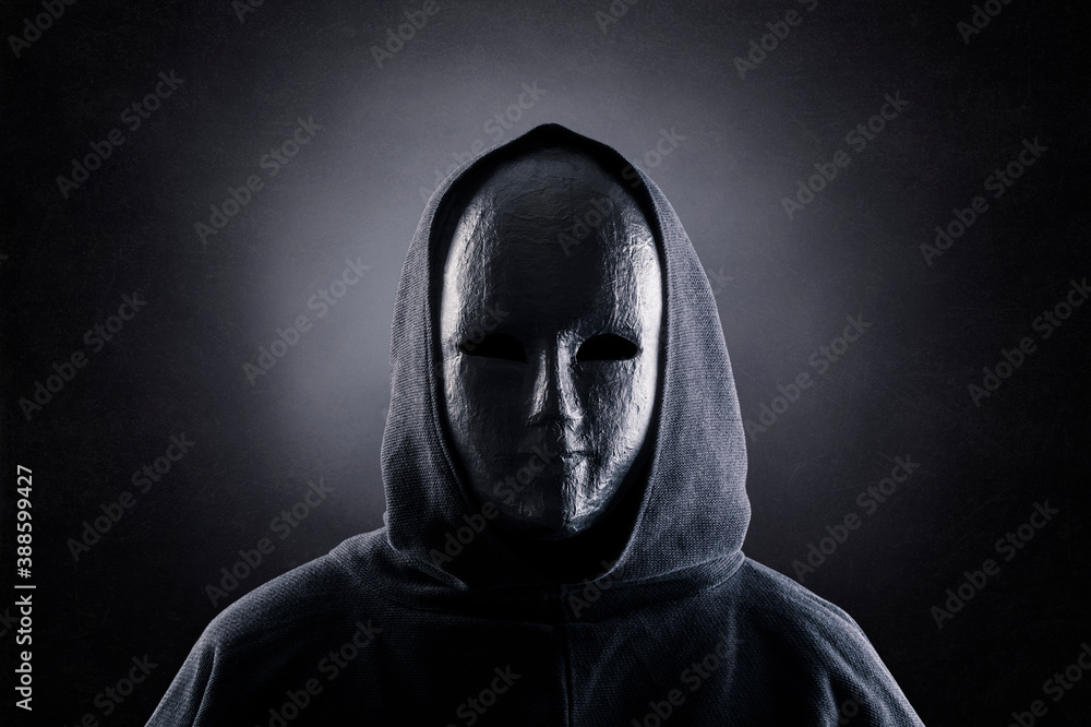 Fototapeta premium Portrait of a scary figure in hooded cloak