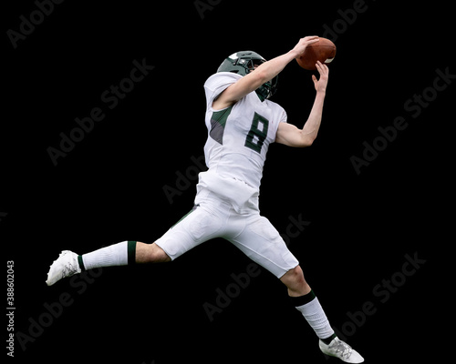 Football players displaying amazing athletic ability while making plays during a game © Joe