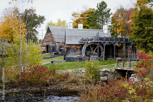 The Saugus Iron Works Forge and Slitting Mill surrounded by colorful fall foliage - landscape photo