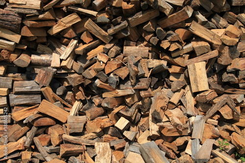 Firewood. Alternative and cheap energy source for heating. Heating season. Background and texture of wooden logs. Wooden fuel. Stock of renewable resources for the winter when energy prices rise