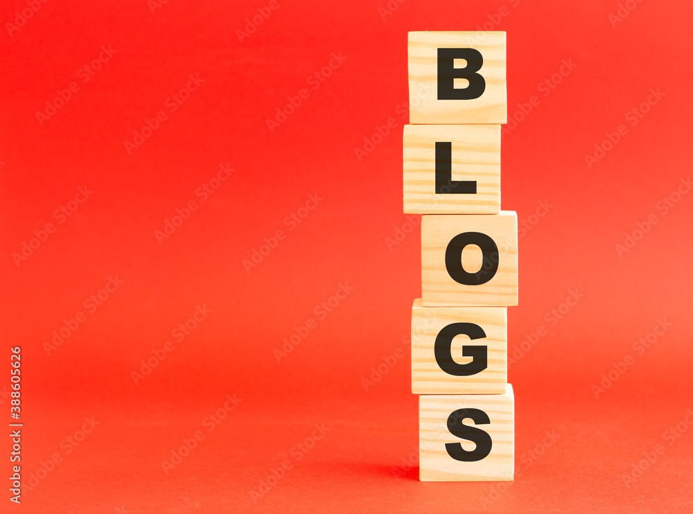 Wooden cubes with letters. Wooden cubes on a red background. Free space on the left. Wooden cubes with letters. Wooden cubes on a red background. Free space on the left.
