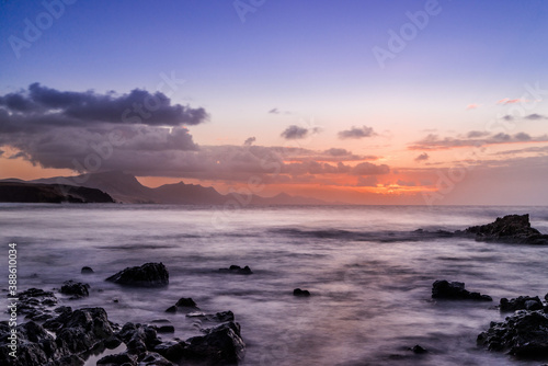 Waves and sunset at the coastline of Fuerteventura