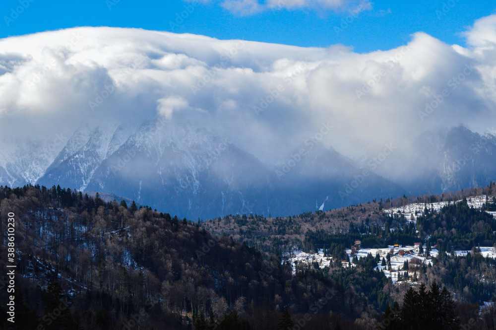 Mountain view with clouds over the peak during winter time
